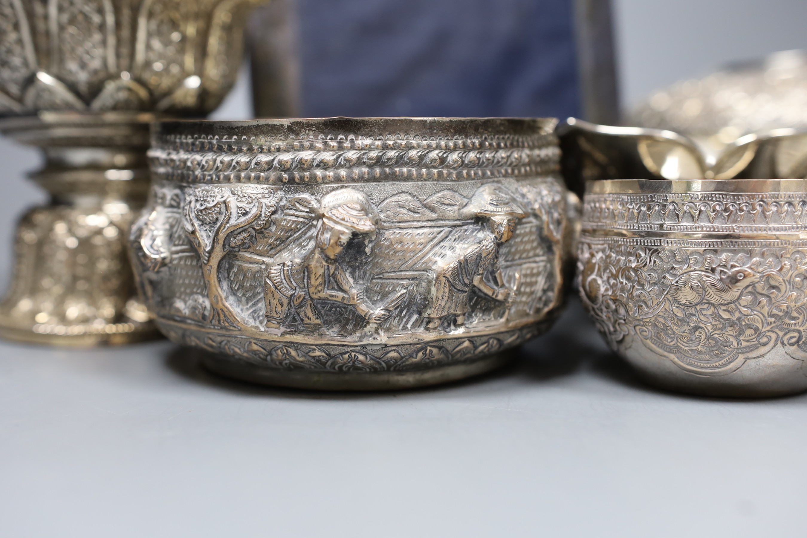 Six assorted embossed Thai white metal bowls, largest 18cm diam., and a silver photograph frame